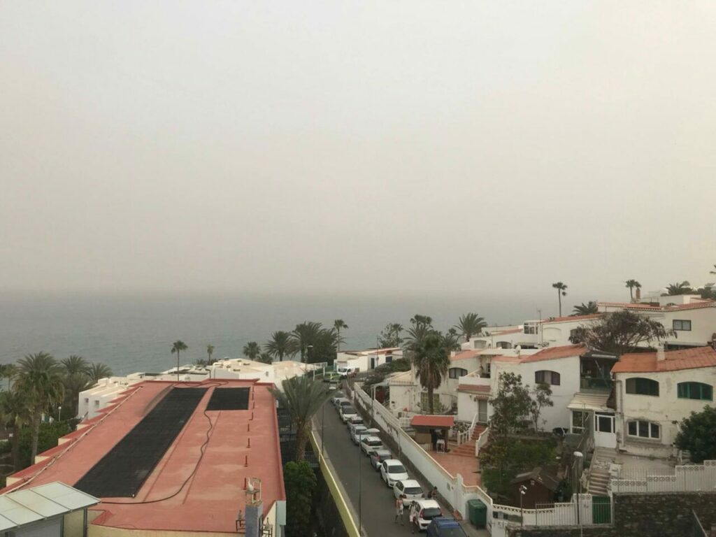 Calima on the coast of the Canary Islands – haze over the sea and the resort