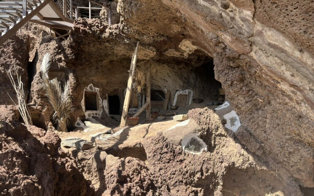 A cave with a display of sealed granaries and clay pots at Cenobio de Valerón