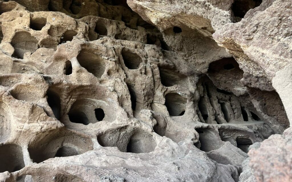 The rock face with the niches of the Cenobio de Valerón granary, resembling a honeycomb