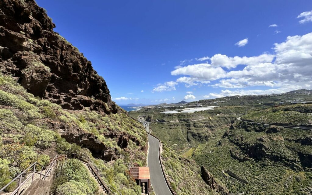 Steps up the hillside to the Cenobio de Valerón granary with a view of the sea