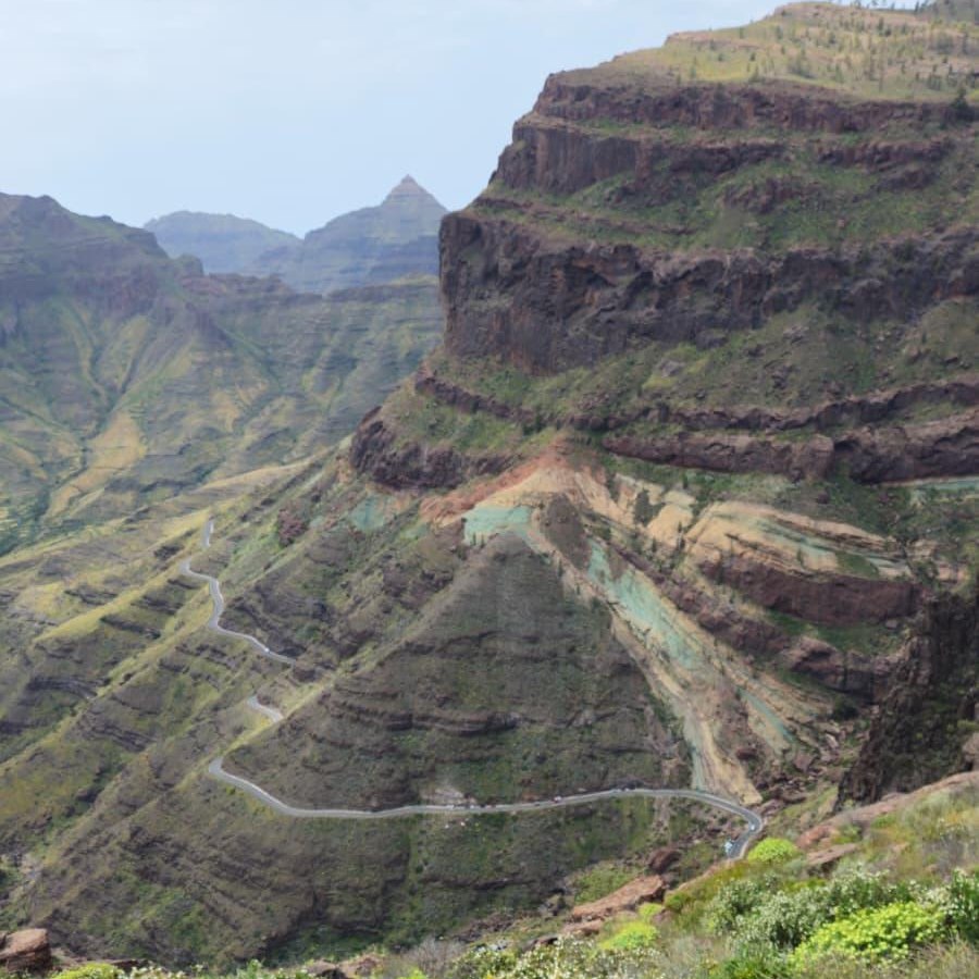 The colourful rocks of Fuente de los Azulejos and a winding road on Gran Canaria