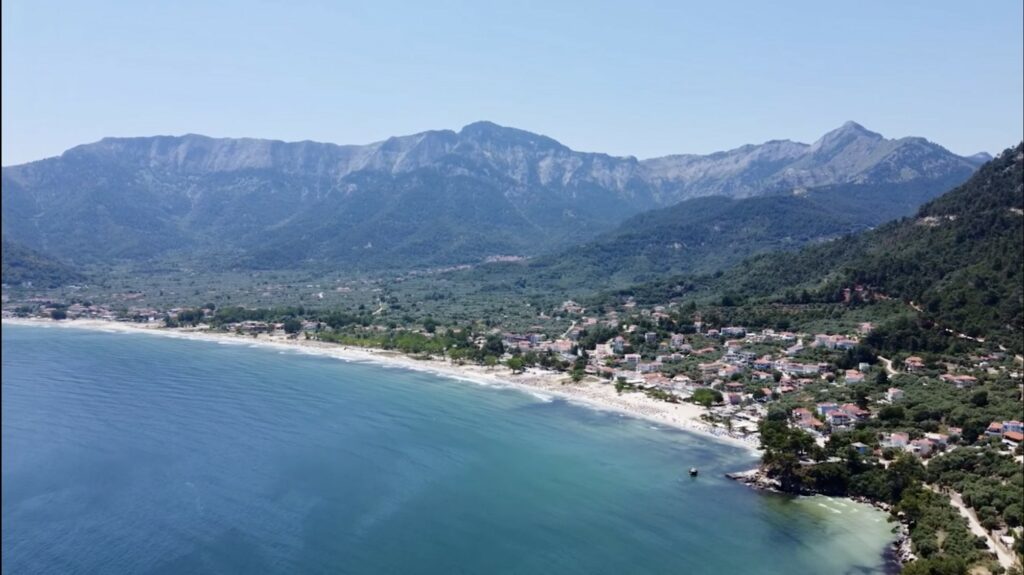 The coast at Skala Potamia, or Golden Beach, with the island's highest peak, Ipsarion, rising above it