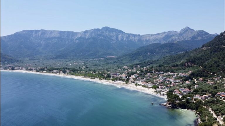 The coast at Skala Potamia, or Golden Beach, with the island's highest peak, Ipsarion, rising above it