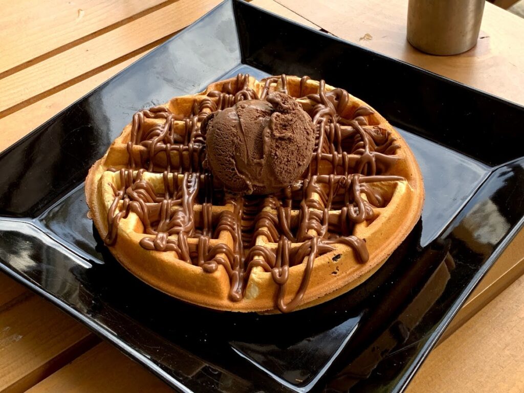 A waffle with chocolate by the square with the spring of love in the village of Panagia on Thassos