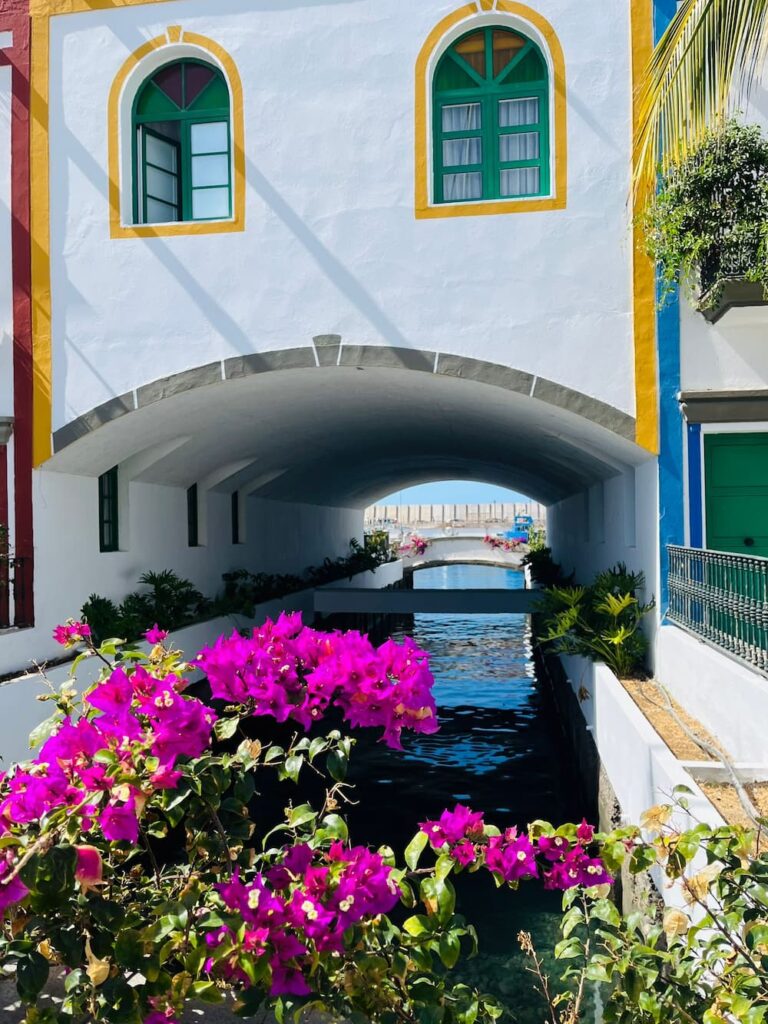 Flowers and a canal in Puerto de Mogán, the Venice of the Canaries