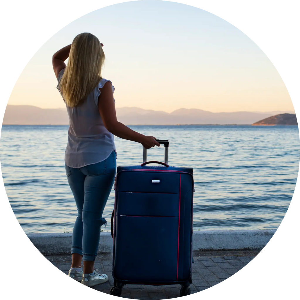 A tour rep with a suitcase on the waterfront in Limenas, the capital of Thassos
